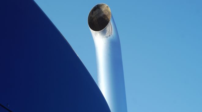 Exhaust pipe against a blue sky (jacquesdurocher/GettyImages)