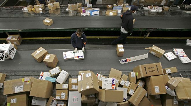 FedEx workers sort packages